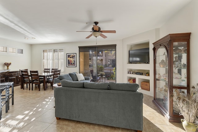 living room featuring ceiling fan and light tile patterned flooring