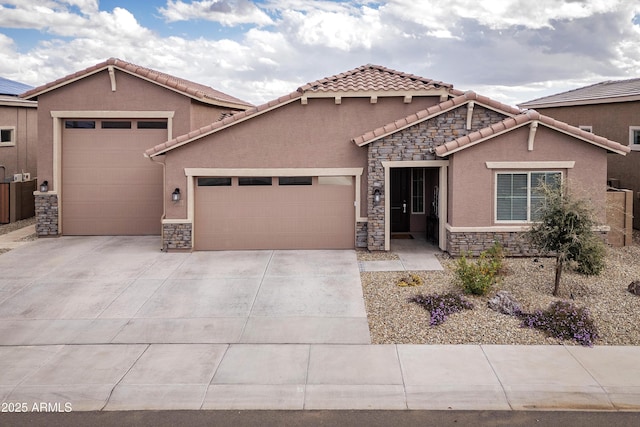 view of front facade featuring a garage, driveway, stone siding, a tile roof, and stucco siding