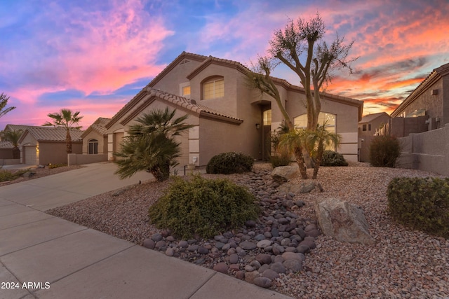 mediterranean / spanish-style home featuring a garage