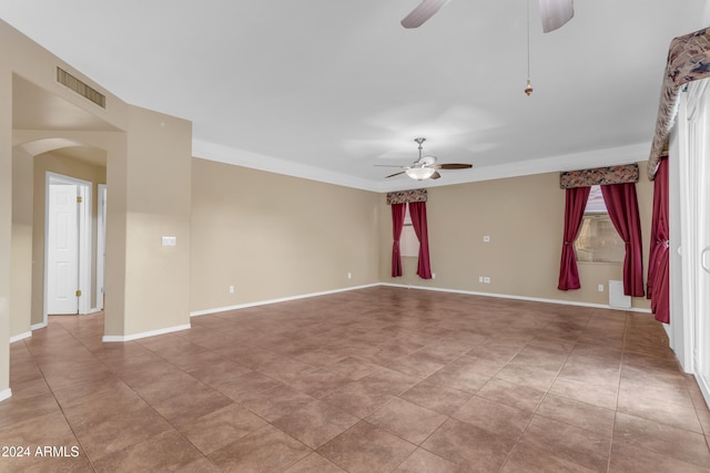 empty room with ceiling fan and crown molding