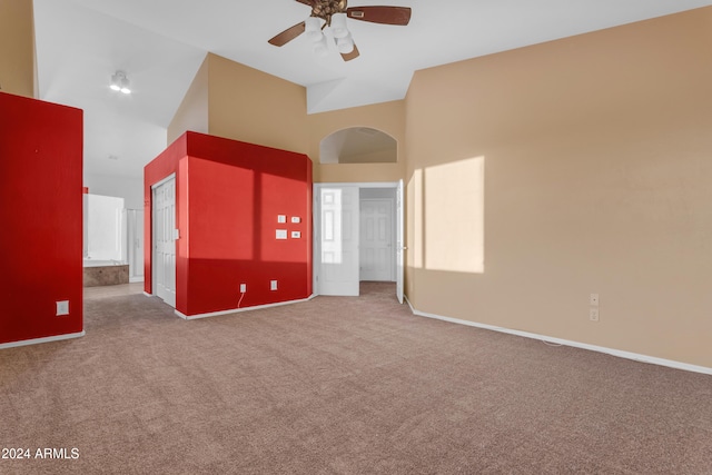 carpeted empty room featuring ceiling fan and high vaulted ceiling