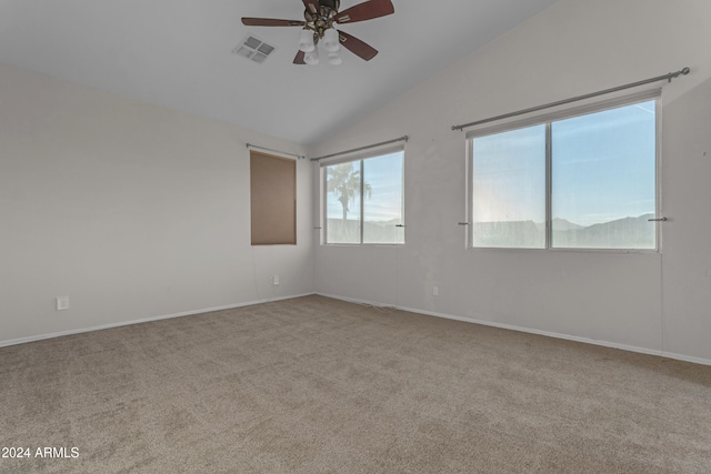 carpeted spare room with ceiling fan and lofted ceiling