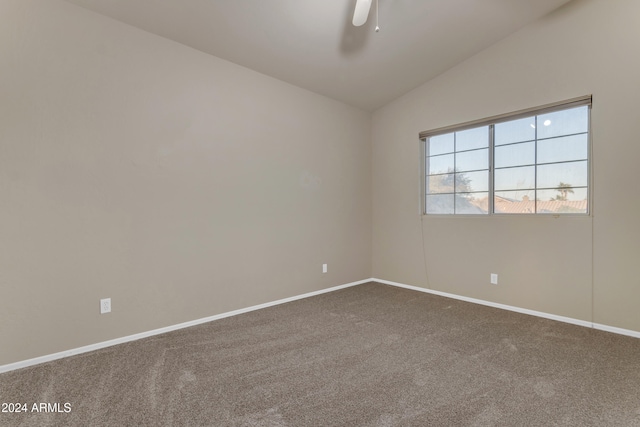 carpeted empty room with ceiling fan and lofted ceiling