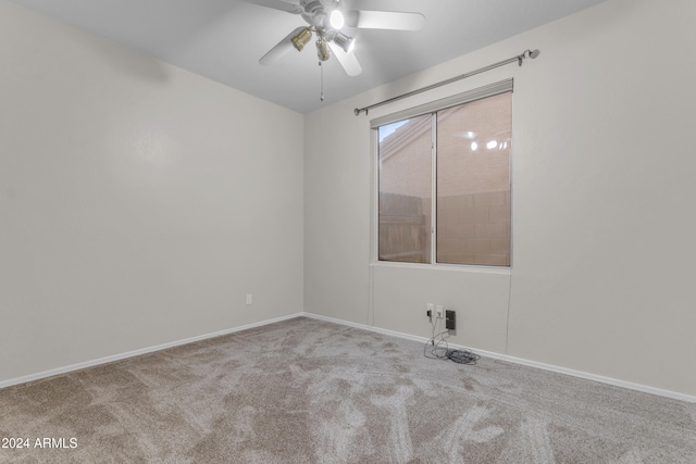 unfurnished room featuring ceiling fan and light colored carpet