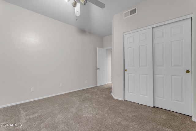 unfurnished bedroom featuring carpet, a closet, and ceiling fan