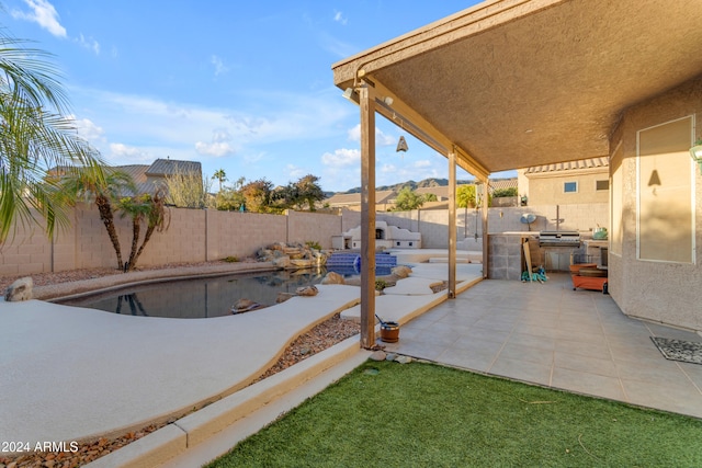 view of pool featuring area for grilling and a patio area