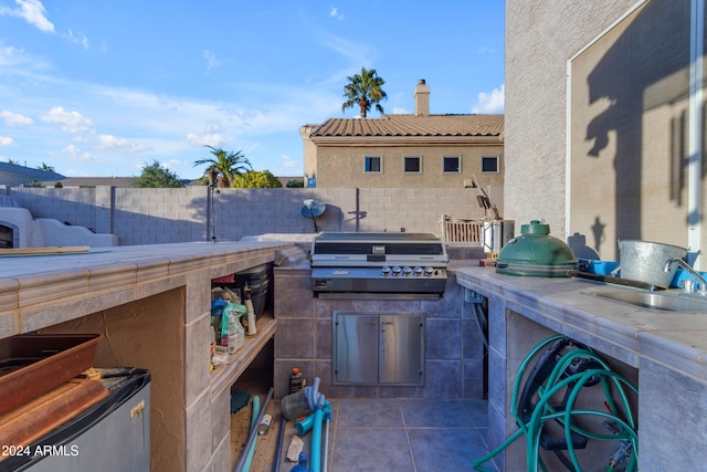 view of patio with sink, area for grilling, and a grill