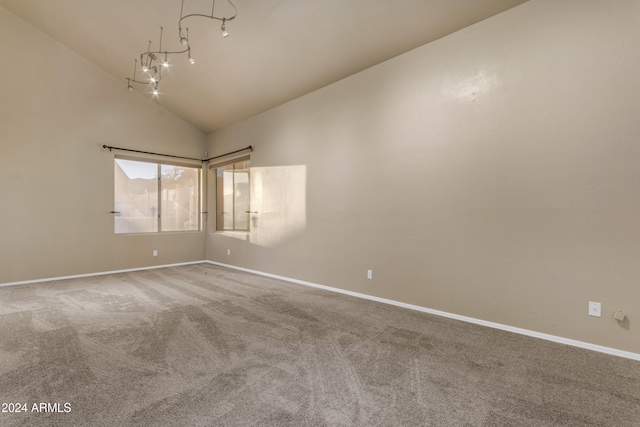 unfurnished room with carpet flooring and high vaulted ceiling