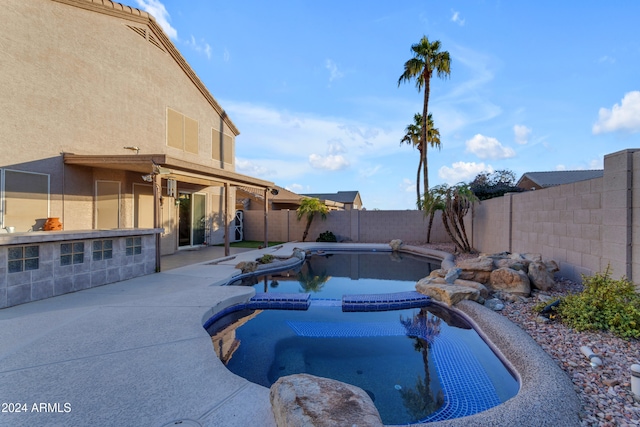 view of pool featuring a patio area and an in ground hot tub