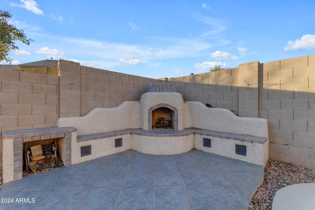 view of patio / terrace featuring an outdoor fireplace