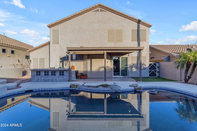 view of swimming pool with a bar and a patio