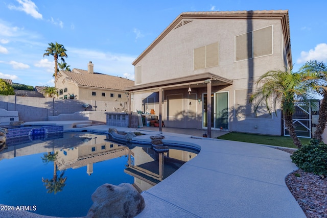 view of pool featuring a patio area and an in ground hot tub