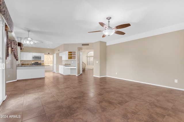 unfurnished living room featuring ceiling fan