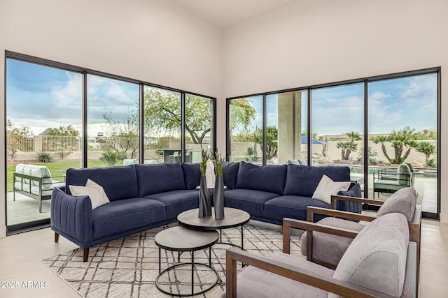 living room featuring a towering ceiling