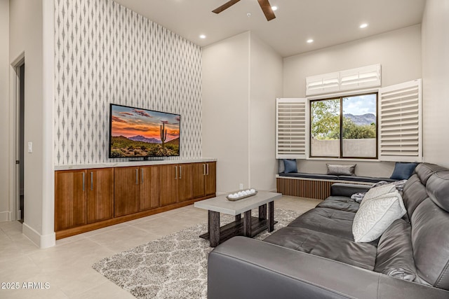 tiled living room featuring a towering ceiling and ceiling fan