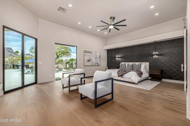 bedroom with light hardwood / wood-style floors and access to outside