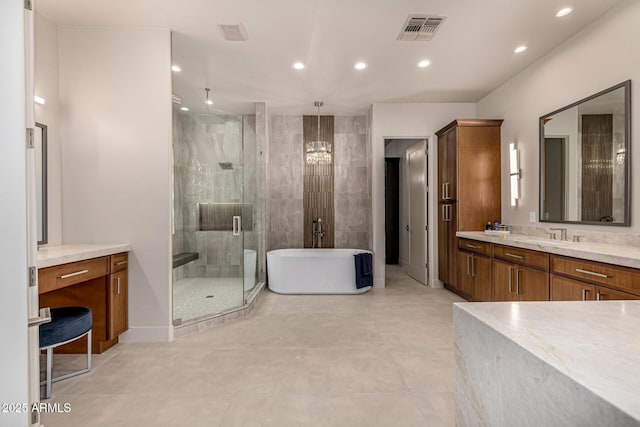 bathroom with vanity and independent shower and bath