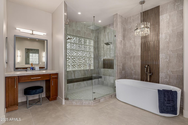 bathroom with vanity, separate shower and tub, tile patterned flooring, and tile walls