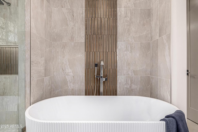 bathroom with tile walls and a bathing tub