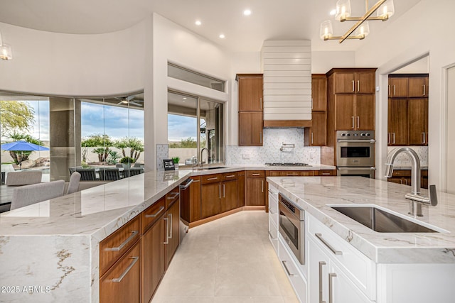 kitchen featuring appliances with stainless steel finishes, pendant lighting, tasteful backsplash, white cabinetry, and sink