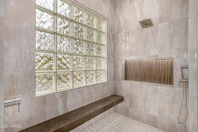 bathroom featuring a tile shower