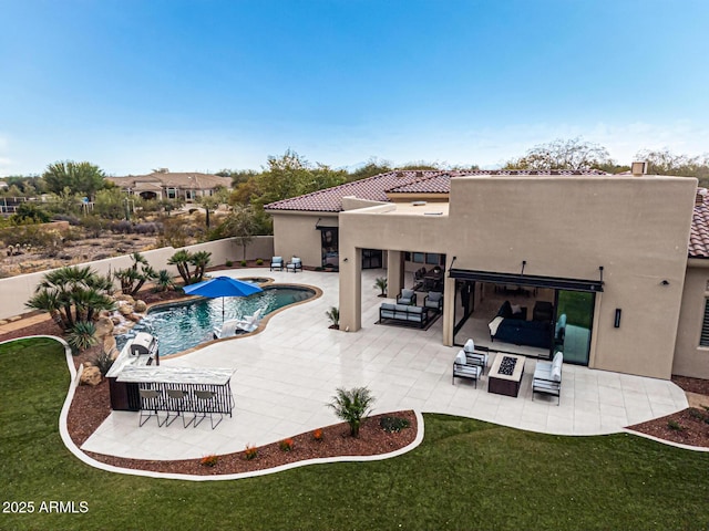 view of swimming pool featuring a yard, outdoor lounge area, and a patio