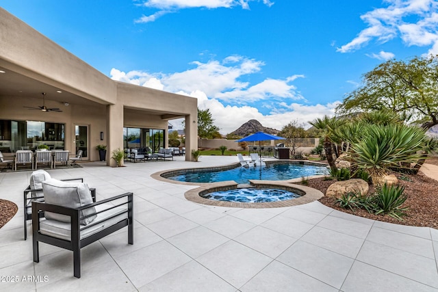 view of pool with an in ground hot tub, ceiling fan, an outdoor living space, and a patio