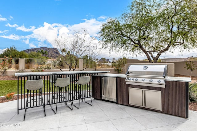 view of patio / terrace featuring area for grilling and a mountain view