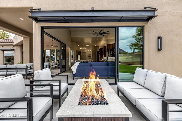 view of patio featuring an outdoor living space with a fire pit