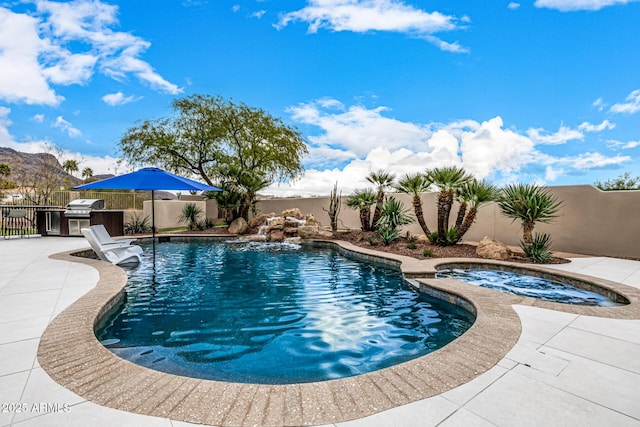 view of pool with a patio area and an in ground hot tub