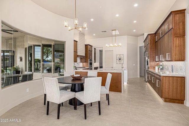 tiled dining room featuring an inviting chandelier