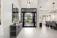 foyer entrance featuring a notable chandelier