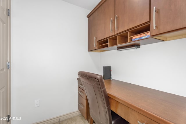 office area featuring baseboards and built in desk