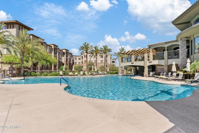 pool with a residential view, a patio, and fence