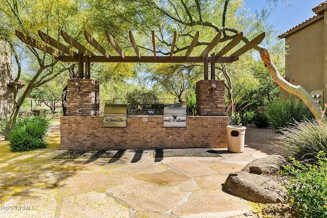 view of patio featuring area for grilling, a pergola, and a grill