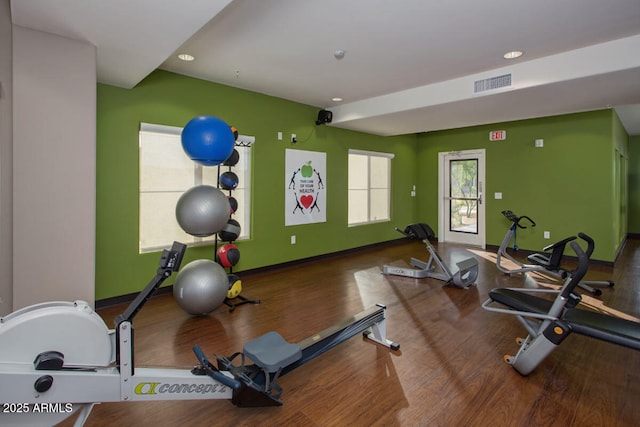 gym with recessed lighting, visible vents, baseboards, and wood finished floors