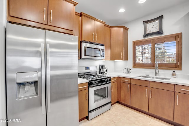 kitchen featuring a sink, recessed lighting, stainless steel appliances, light countertops, and light tile patterned floors