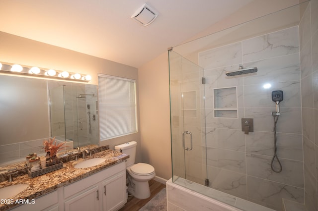 bathroom with walk in shower, toilet, vaulted ceiling, vanity, and hardwood / wood-style flooring