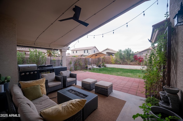 view of patio featuring grilling area and an outdoor living space with a fire pit