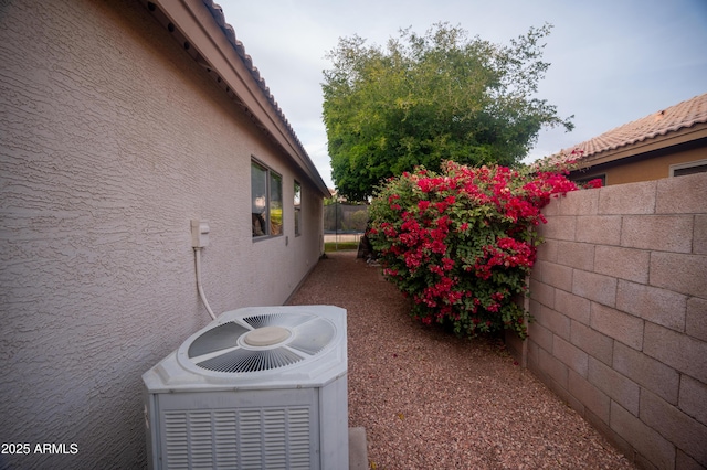 view of side of property featuring central AC unit