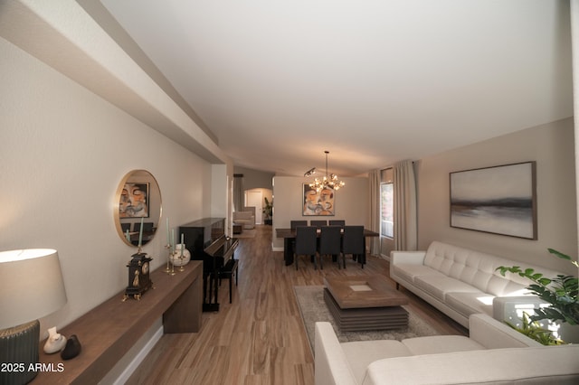 living room with light hardwood / wood-style flooring and a chandelier