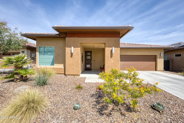 13204 W Via Dona Rd, Peoria, AZ 85383 - view of front facade featuring driveway, stucco siding, and a garage