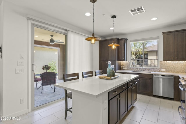 13204 W Via Dona Rd, Peoria, AZ 85383 - kitchen featuring a kitchen breakfast bar, decorative backsplash, a sink, visible vents, and appliances with stainless steel finishes