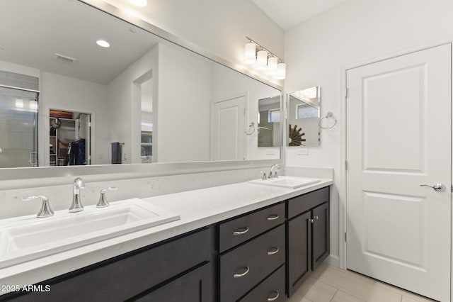 13204 W Via Dona Rd, Peoria, AZ 85383 - bathroom featuring visible vents, a sink, a spacious closet, and double vanity
