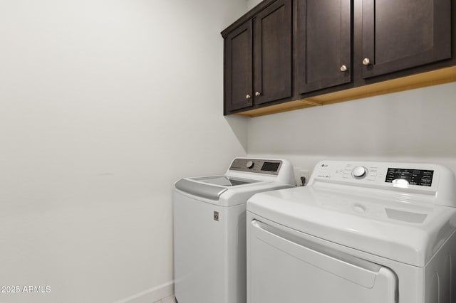 13204 W Via Dona Rd, Peoria, AZ 85383 - clothes washing area with washing machine and clothes dryer, cabinet space, and baseboards