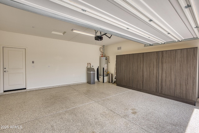 13204 W Via Dona Rd, Peoria, AZ 85383 - garage with visible vents, gas water heater, and a garage door opener
