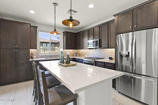 13204 W Via Dona Rd, Peoria, AZ 85383 - kitchen with a sink, stainless steel appliances, dark brown cabinetry, and visible vents