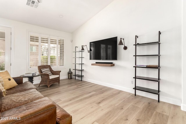 18614 E Oriole Way, Queen Creek, AZ 85142 - living room featuring light wood-style floors, lofted ceiling, and baseboards