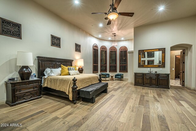 interior space with decorative light fixtures, light tile patterned floors, dark stone countertops, wine cooler, and kitchen peninsula