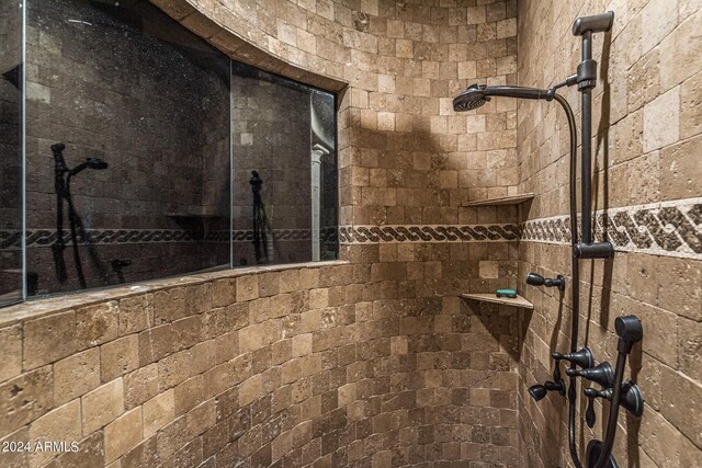 bathroom with vanity, tile patterned flooring, tiled bath, and a towering ceiling